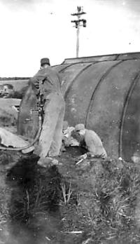 Refueling Oil For The Hut Heater; Using Discarded Wing Tank To Store Oil. [Robert Koppen]